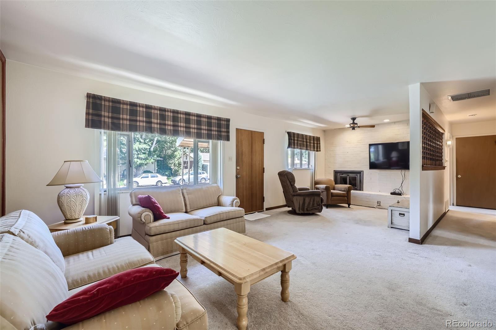 6290 Janice Way Arvada, CO 80004 - Photo 11 of 28 a living room with furniture and a flat screen tv