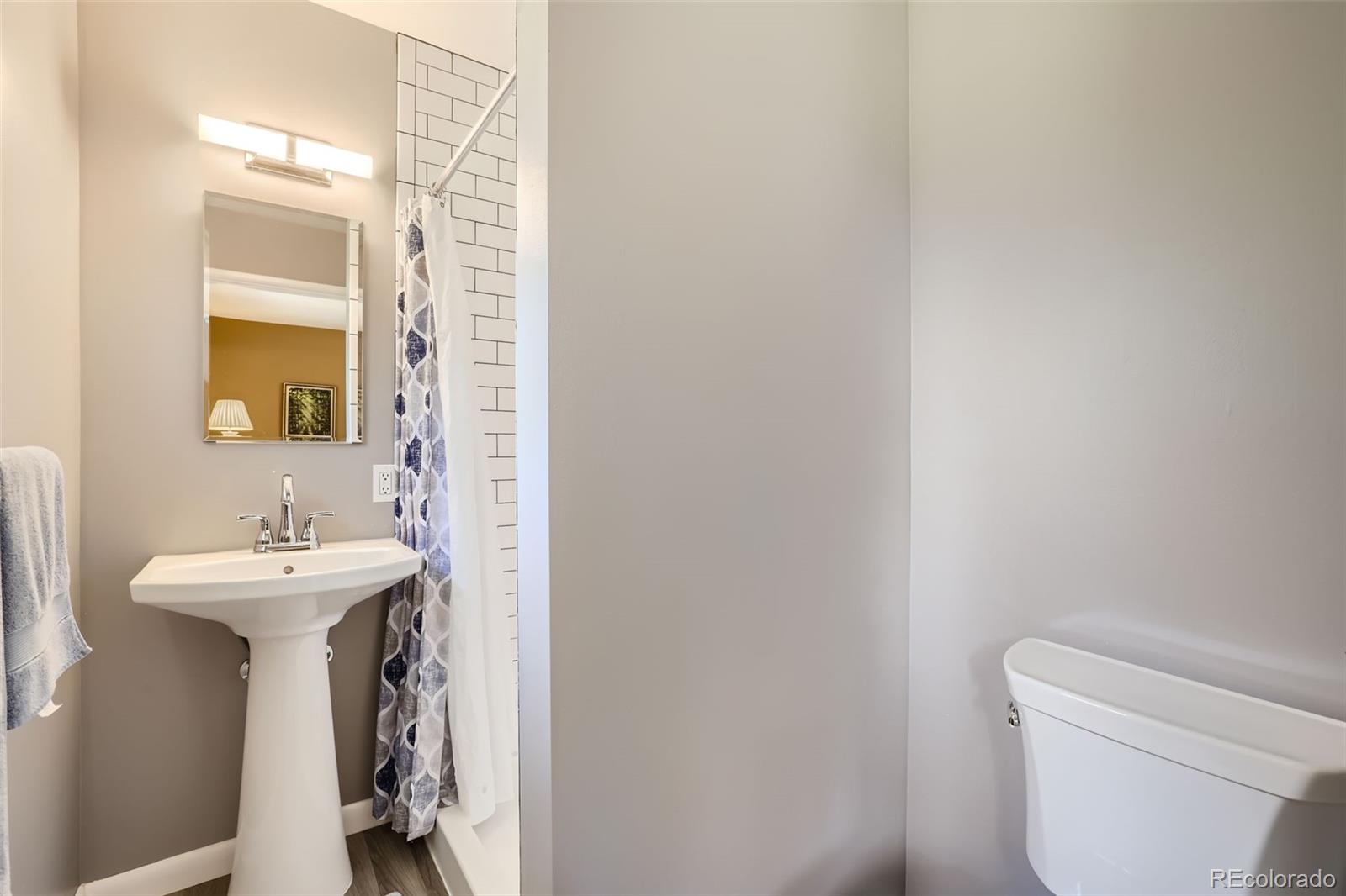 6290 Janice Way Arvada, CO 80004 - Photo 17 of 28 a bathroom with a sink a toilet and mirror