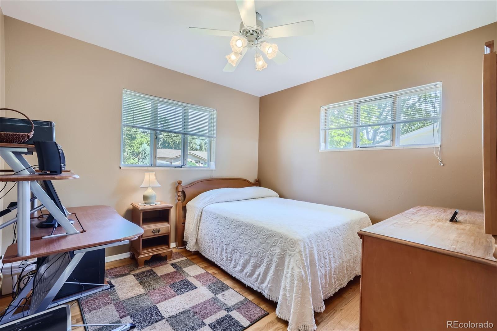 6290 Janice Way Arvada, CO 80004 - Photo 19 of 28 a bedroom with a bed a table and chair