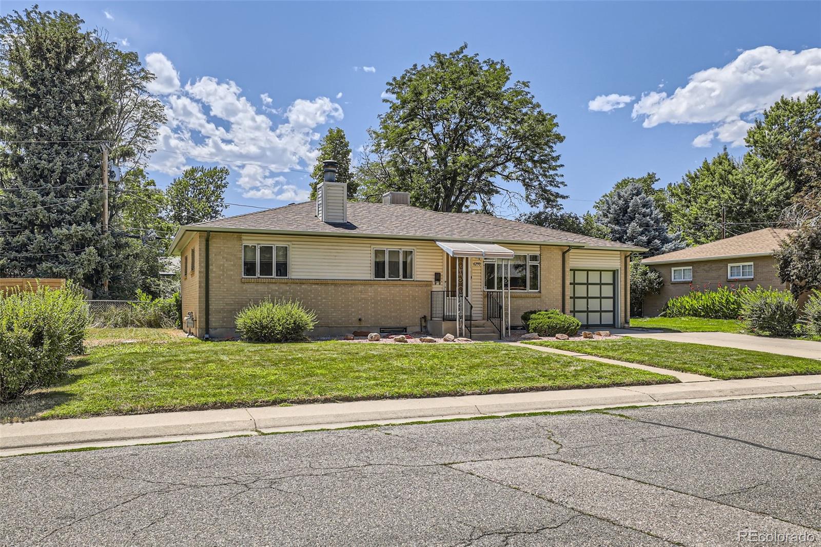 6290 Janice Way Arvada, CO 80004 - Photo 2 of 28 a front view of a house with a yard