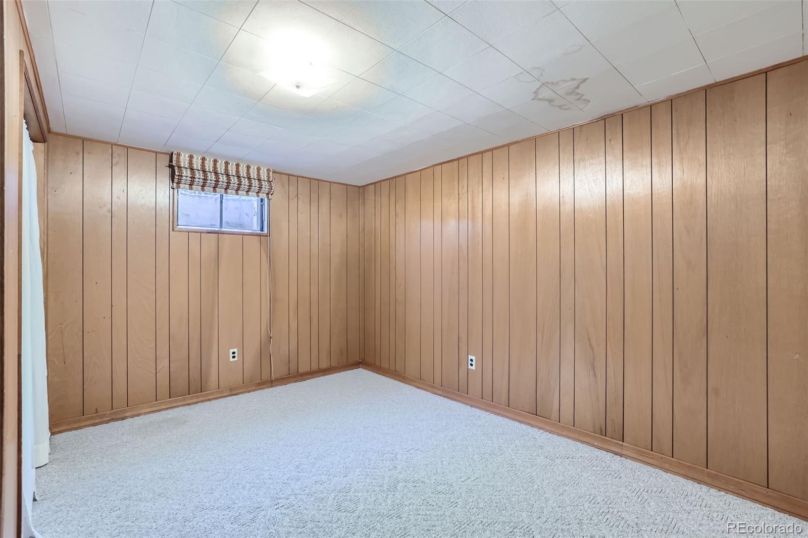 6290 Janice Way Arvada, CO 80004 - Photo 22 of 28 an empty room with wooden walls