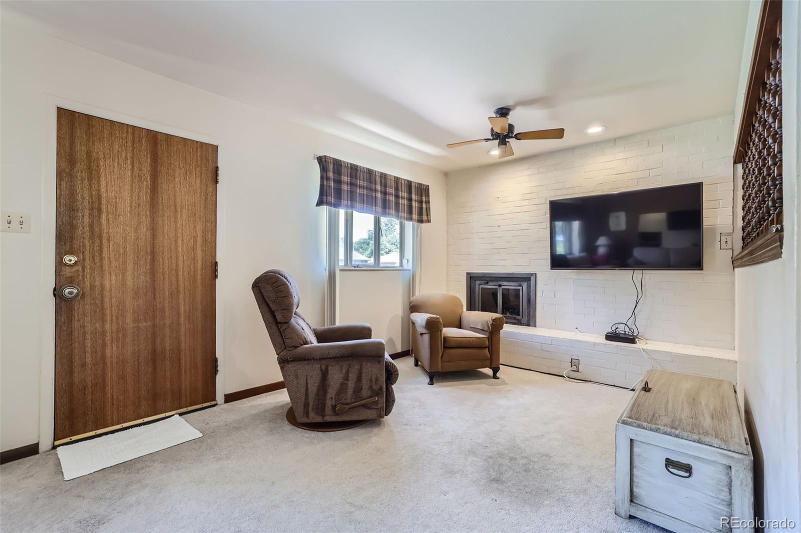 6290 Janice Way Arvada, CO 80004 - Photo 4 of 28 a living room with furniture and a flat screen tv