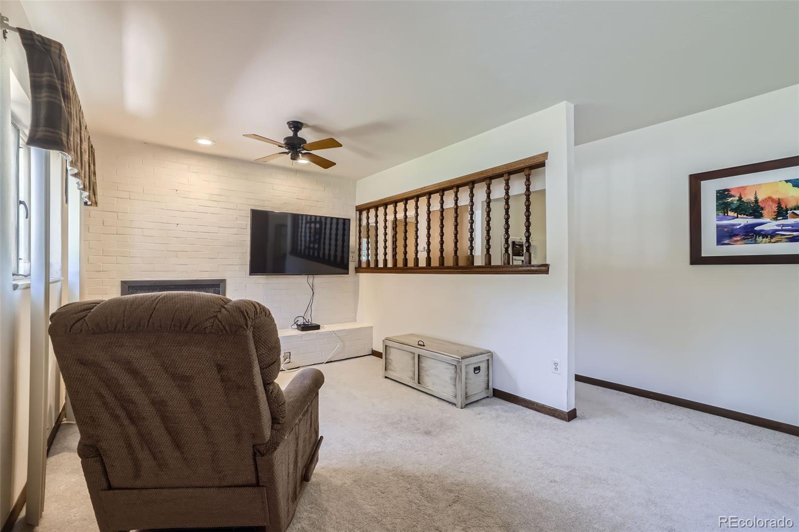6290 Janice Way Arvada, CO 80004 - Photo 5 of 28 a living room with furniture and a flat screen tv