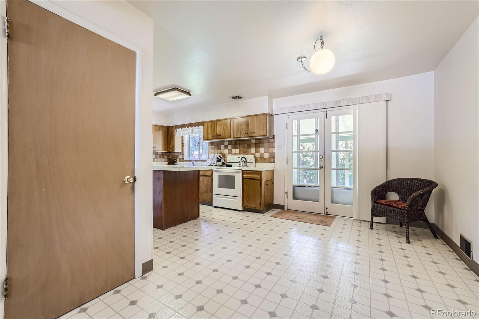 6290 Janice Way Arvada, CO 80004 - Photo 6 of 28 a kitchen with stainless steel appliances a refrigerator and a stove top oven