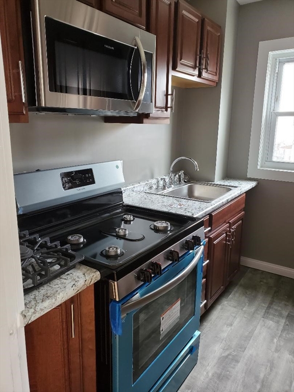 762 Globe Street, Unit 2 Fall River, MA 02724 - Photo 1 of 20 a kitchen with a stove and a microwave