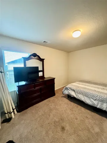 a bedroom with a bed and gym equipment