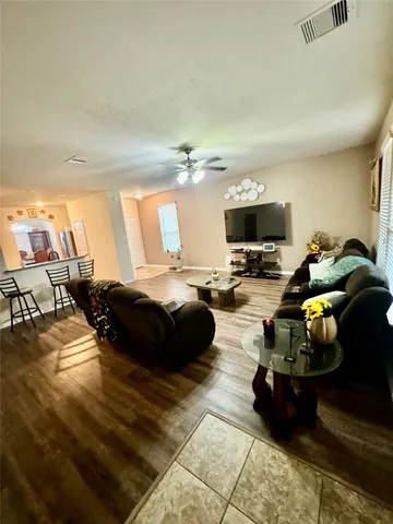 a living room with furniture and a flat screen tv