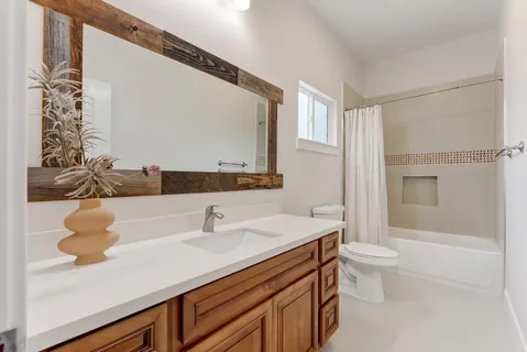 a kitchen with kitchen island stainless steel appliances a sink refrigerator stove and microwave