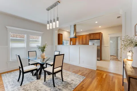 a kitchen with a sink stove and wooden cabinets