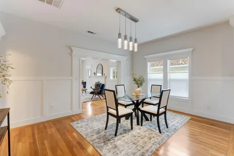 a kitchen with stainless steel appliances granite countertop a sink a stove and a refrigerator