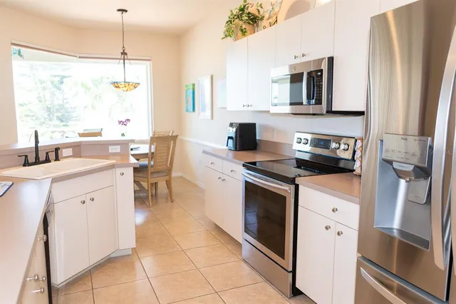 a kitchen with stainless steel appliances a stove sink and microwave