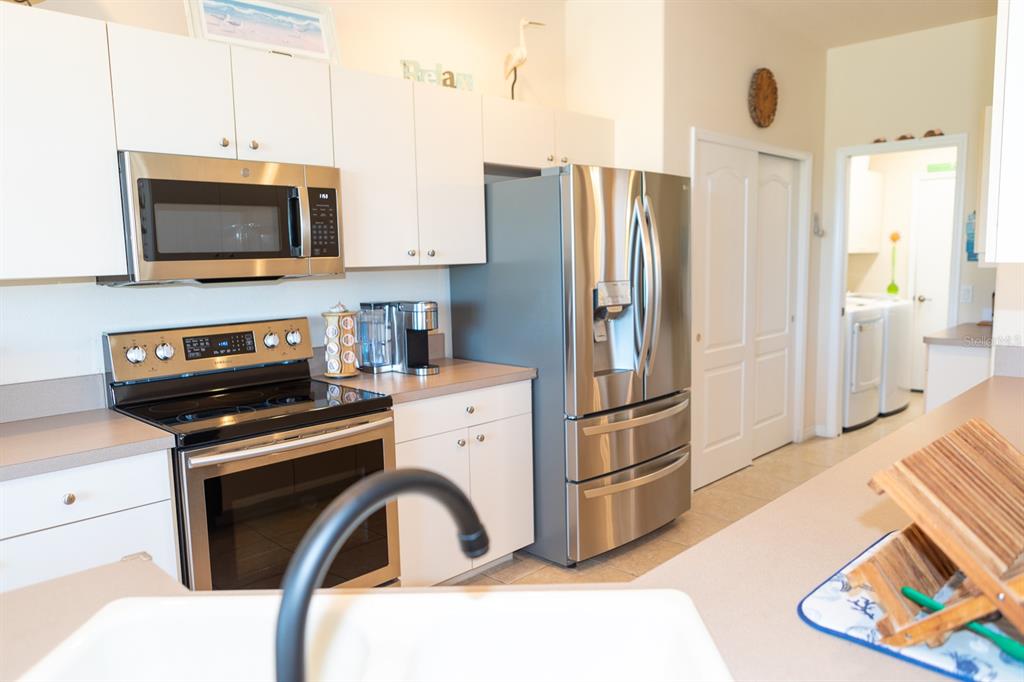 14 Windward Terrace Placida, FL 33946 - Photo 13 of 41 a kitchen with stainless steel appliances a refrigerator a stove a microwave and cabinets