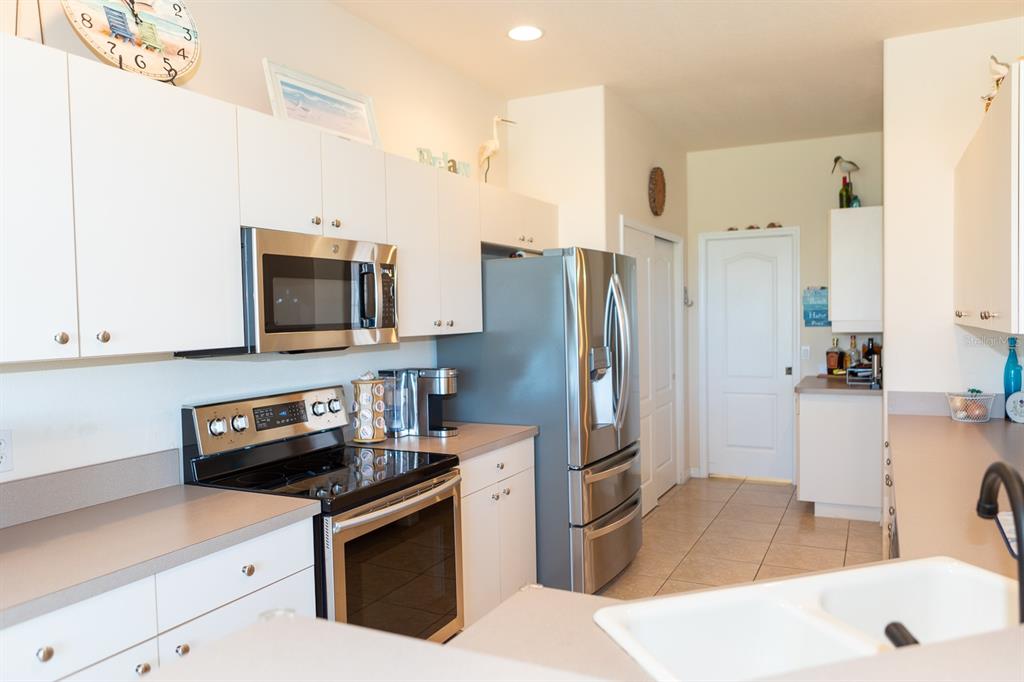 14 Windward Terrace Placida, FL 33946 - Photo 17 of 41 a kitchen with stainless steel appliances a refrigerator a stove a sink and a counter space
