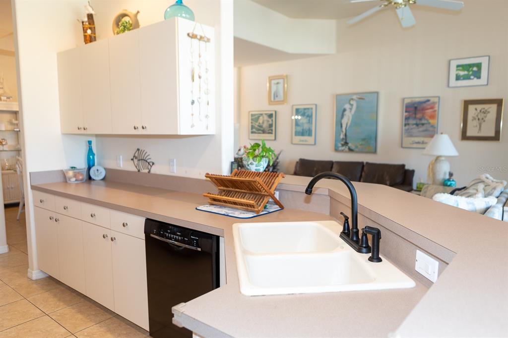14 Windward Terrace Placida, FL 33946 - Photo 18 of 41 a kitchen with stainless steel appliances a sink a stove a table and chairs
