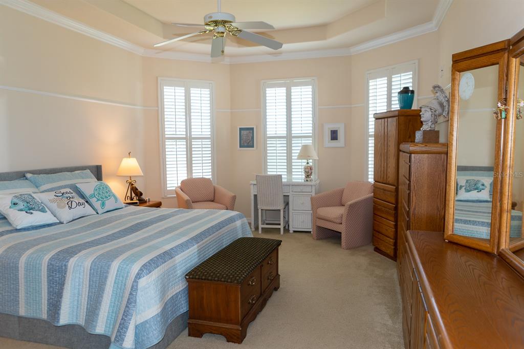 14 Windward Terrace Placida, FL 33946 - Photo 19 of 41 a bedroom with a bed and a chandelier