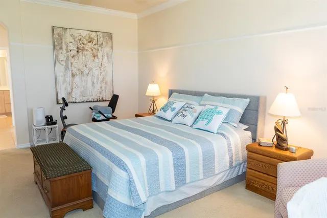 a bedroom with a bed and lamp