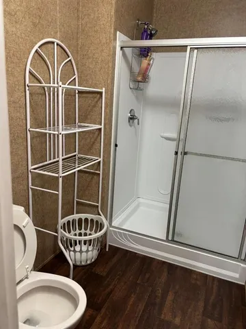 a bathroom with a toilet a sink and shower