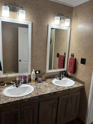 a bathroom with a double vanity sink and a mirror