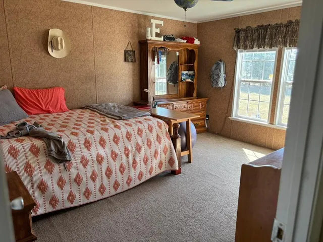 a bedroom with a bed and window