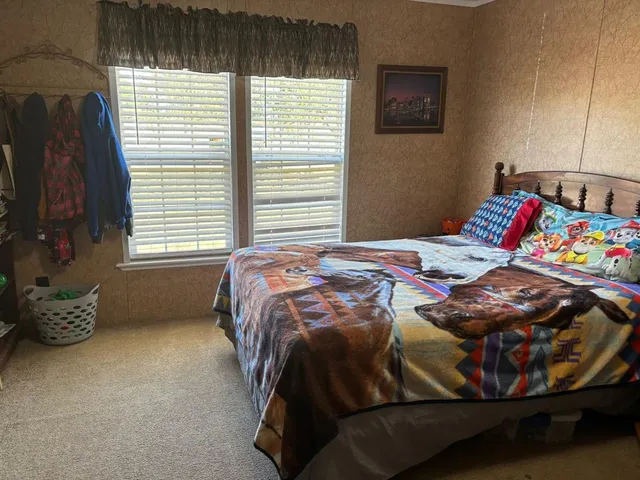 a bedroom with a bed and a window