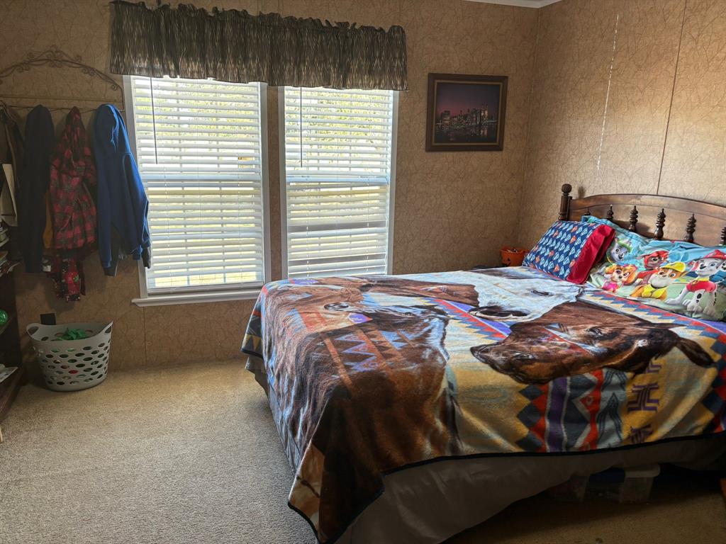 7067 South State Highway 78 Bonham, TX 75418 - Photo 21 of 40 a bedroom with a bed and a window