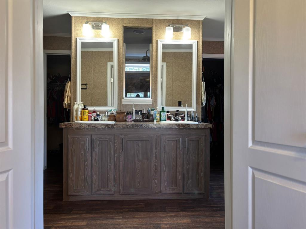 7067 South State Highway 78 Bonham, TX 75418 - Photo 23 of 40 a bathroom with a sink and a mirror