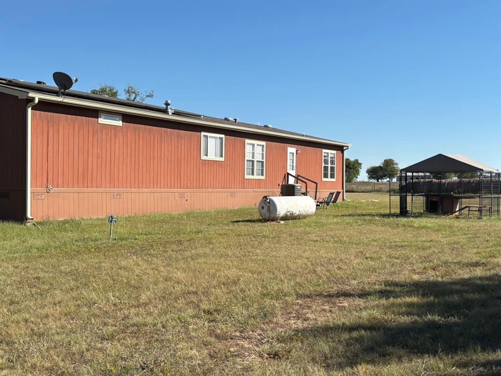 7067 South State Highway 78 Bonham, TX 75418 - Photo 32 of 40 a front view of a house with garden