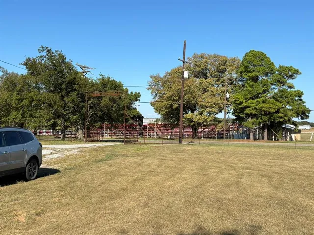 a view of a parking space with a large trees