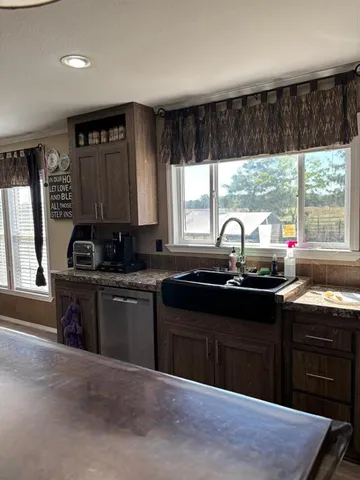 a kitchen with a sink stove and cabinets