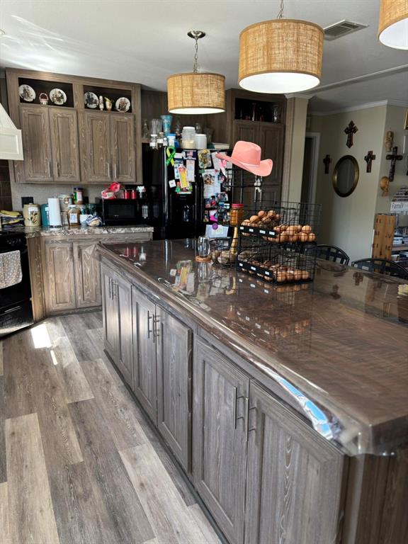 7067 South State Highway 78 Bonham, TX 75418 - Photo 10 of 40 a kitchen with stainless steel appliances granite countertop a stove and a wooden floors