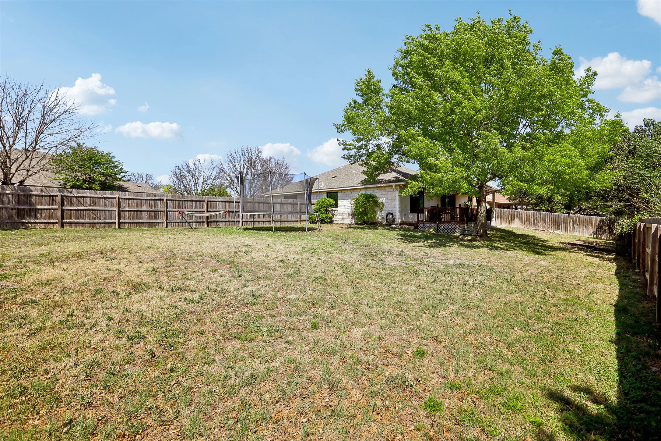 902 Ridgemont Circle Leander, TX 78641 - Photo 23 of 34 a view of a swimming pool with a bench and trees around