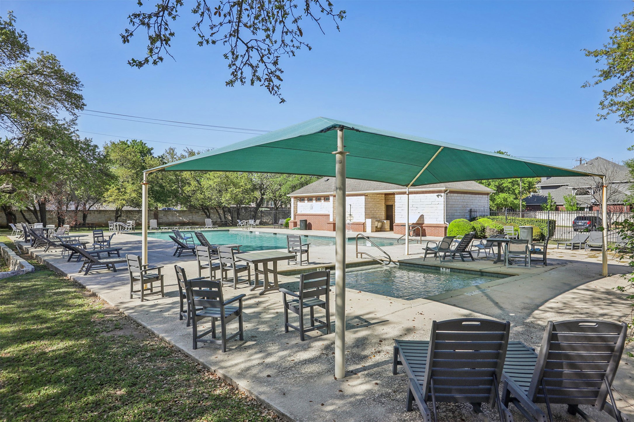 902 Ridgemont Circle Leander, TX 78641 - Photo 33 of 34 a view of a patio with chairs and a table under an umbrella