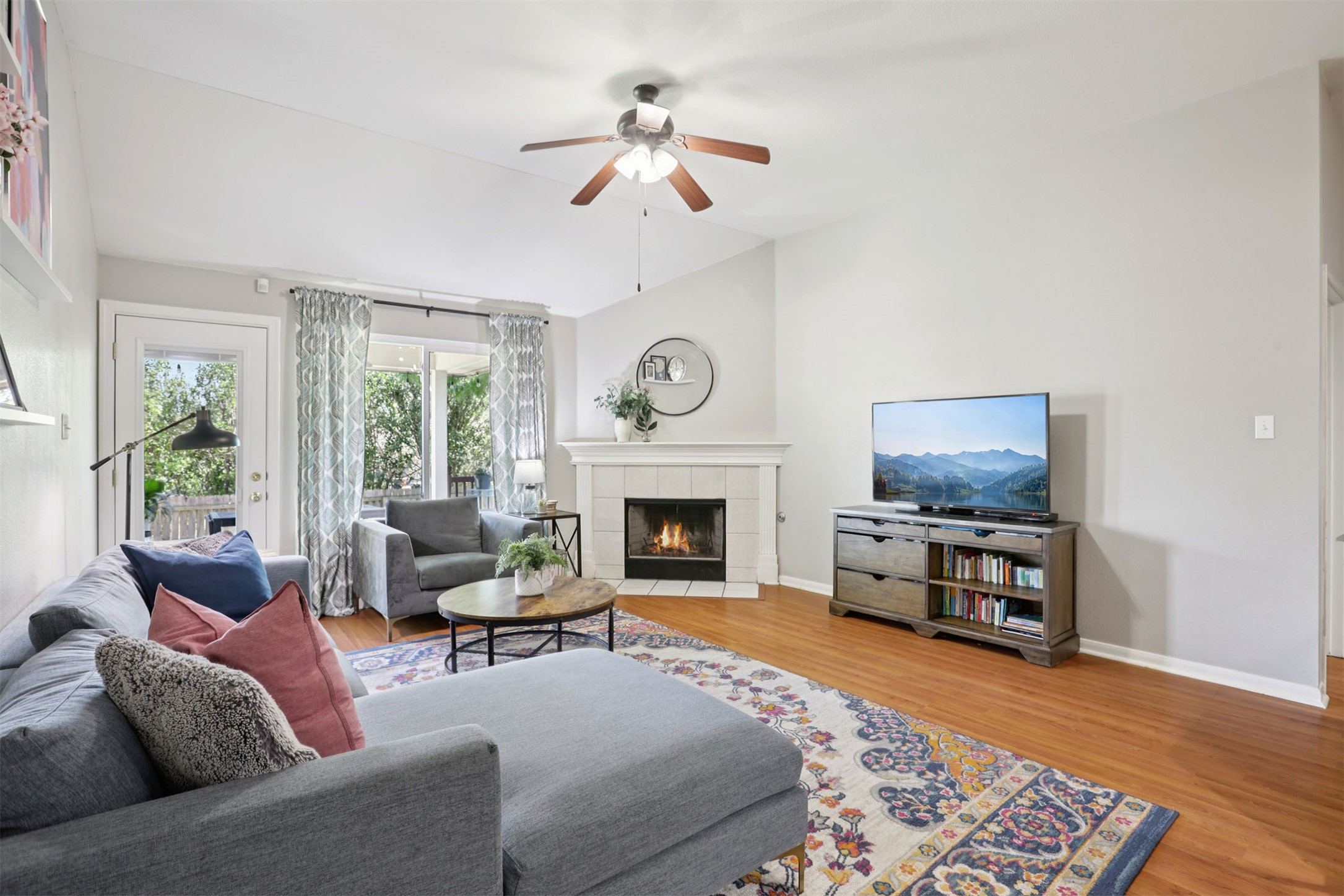 902 Ridgemont Circle Leander, TX 78641 - Photo 5 of 34 a living room with furniture a fireplace and a flat screen tv