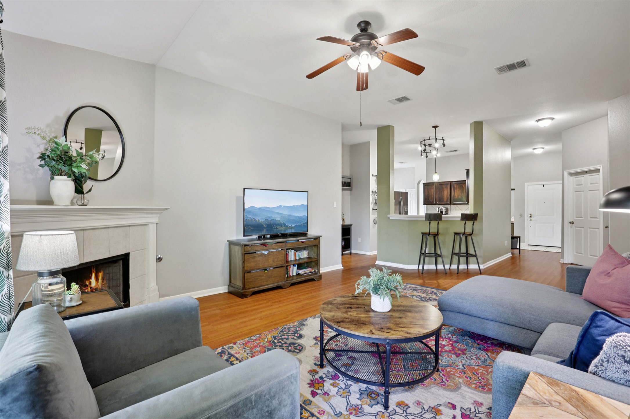 902 Ridgemont Circle Leander, TX 78641 - Photo 6 of 34 a living room with furniture a fireplace and a flat screen tv