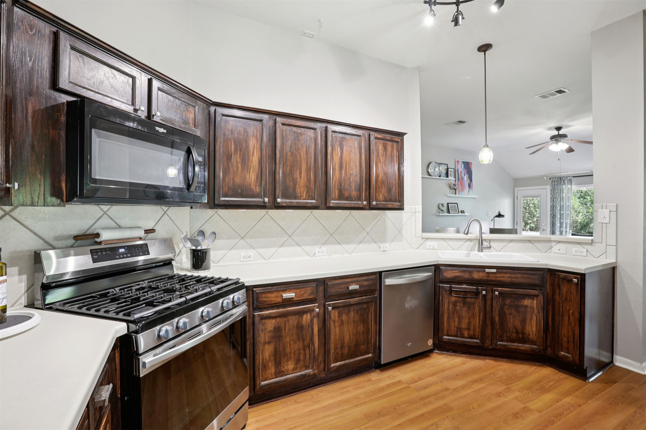 902 Ridgemont Circle Leander, TX 78641 - Photo 8 of 34 a kitchen with stainless steel appliances granite countertop a sink stove and cabinets