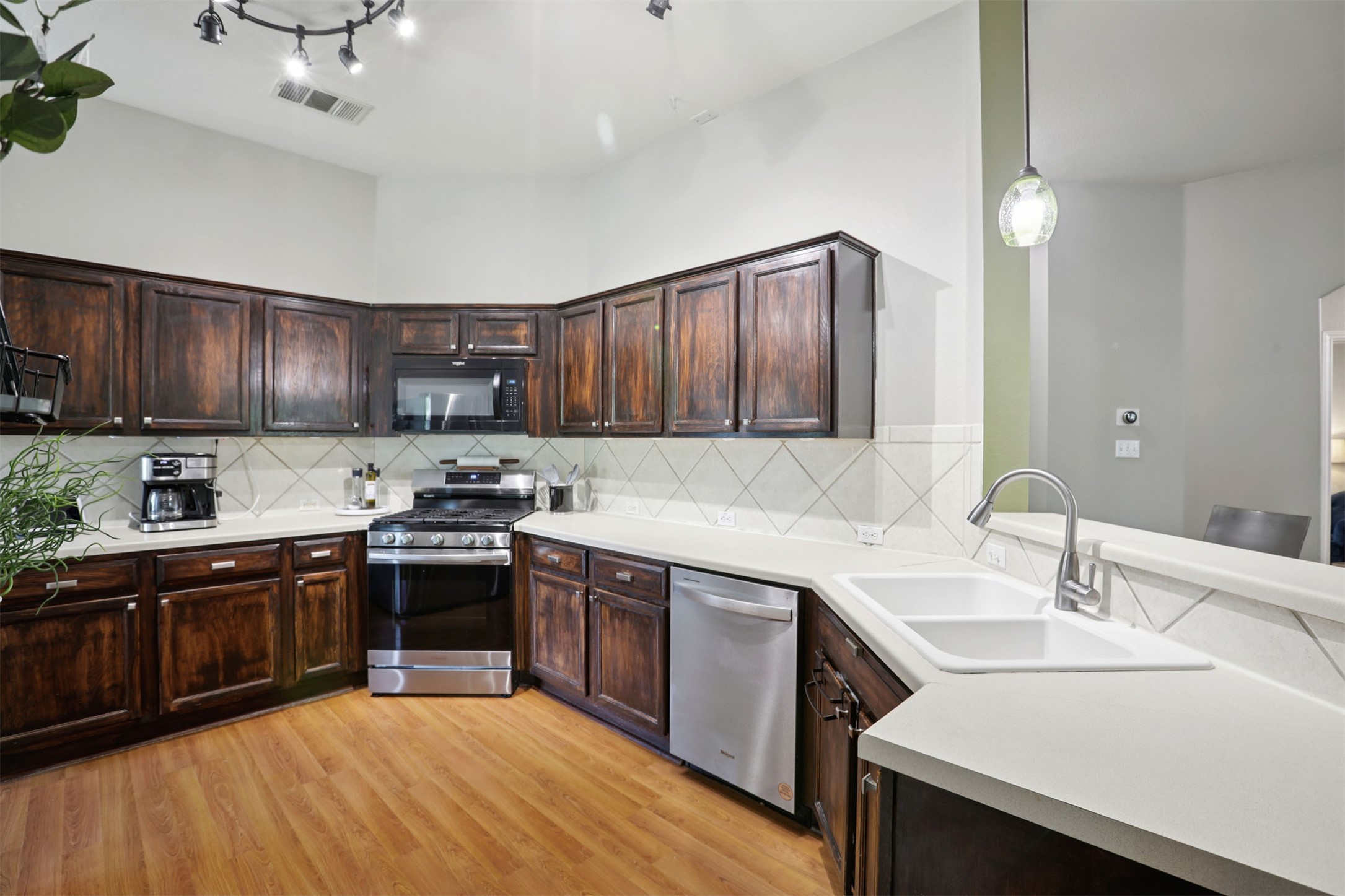 902 Ridgemont Circle Leander, TX 78641 - Photo 9 of 34 a kitchen with stainless steel appliances granite countertop a sink dishwasher stove and oven with wooden cabinets