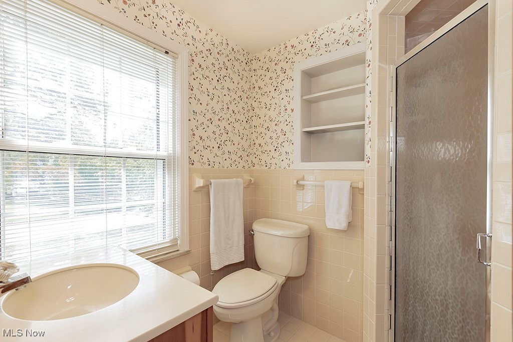 14711 South Woodland Road Cleveland, OH 44120 - Photo 18 of 31 The Ceramic Tiled Bathroom has a Vanity Sink, Toilet, and Stall Shower.