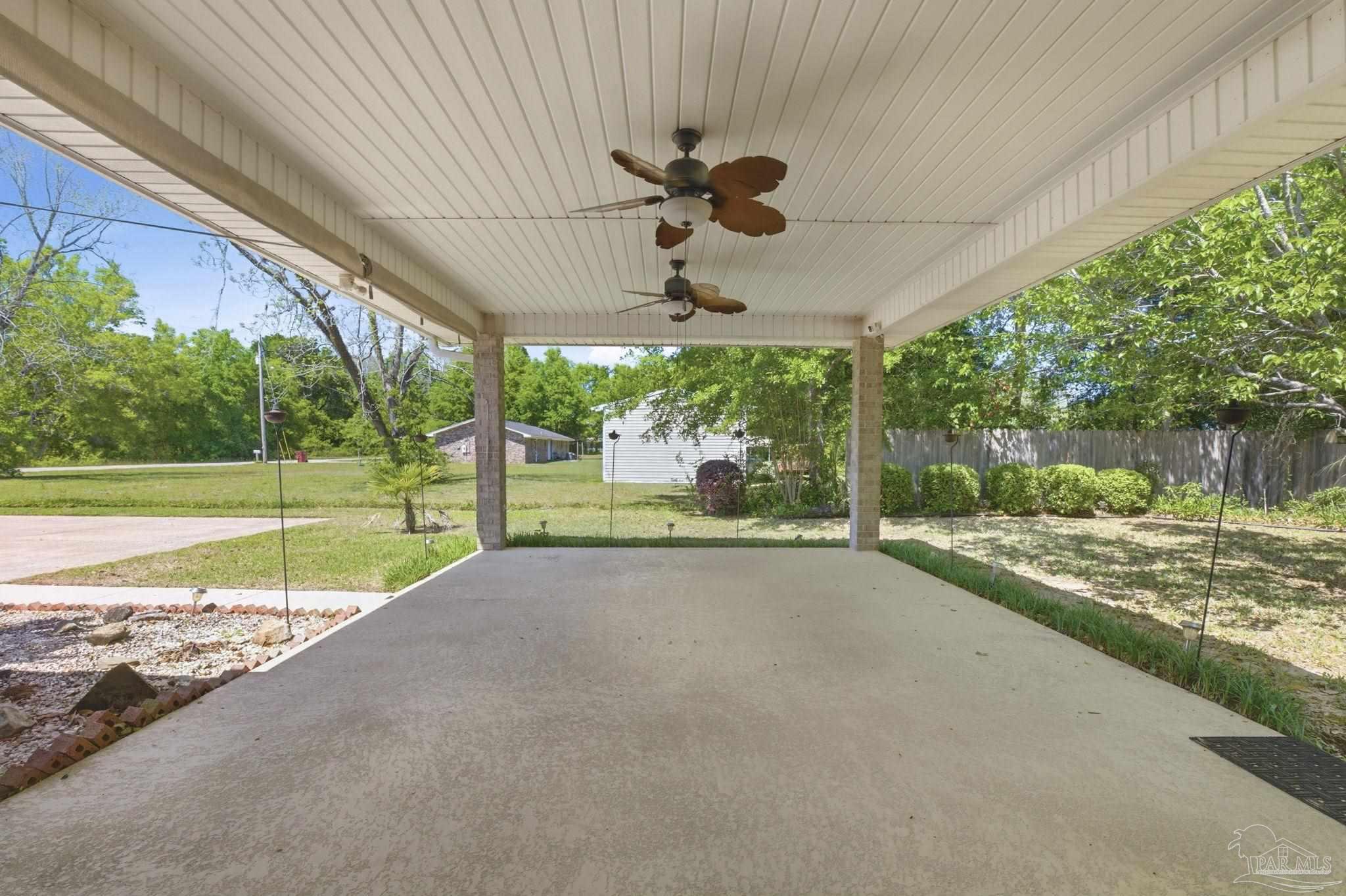 4552 Peaden Road Pace, FL 32571 - Photo 37 of 38 a view of a porch with furniture and garden