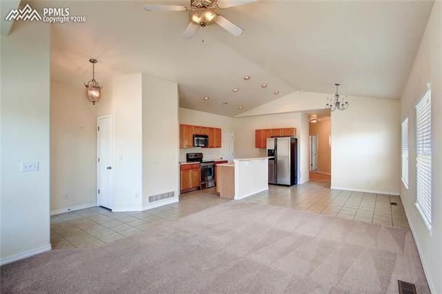724 Rye Ridge Road Fountain, CO 80817 - Photo 8 of 8 Entry greets you with tile floors, vaulted ceiling, neutral colors and a bright and open floor plan, opening to a large living room.