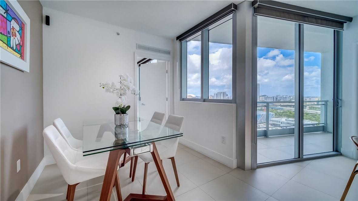 92 Southwest 3rd Street, Unit 1606 Miami, FL 33130 - Photo 11 of 62 a view of a dining room with furniture and a window