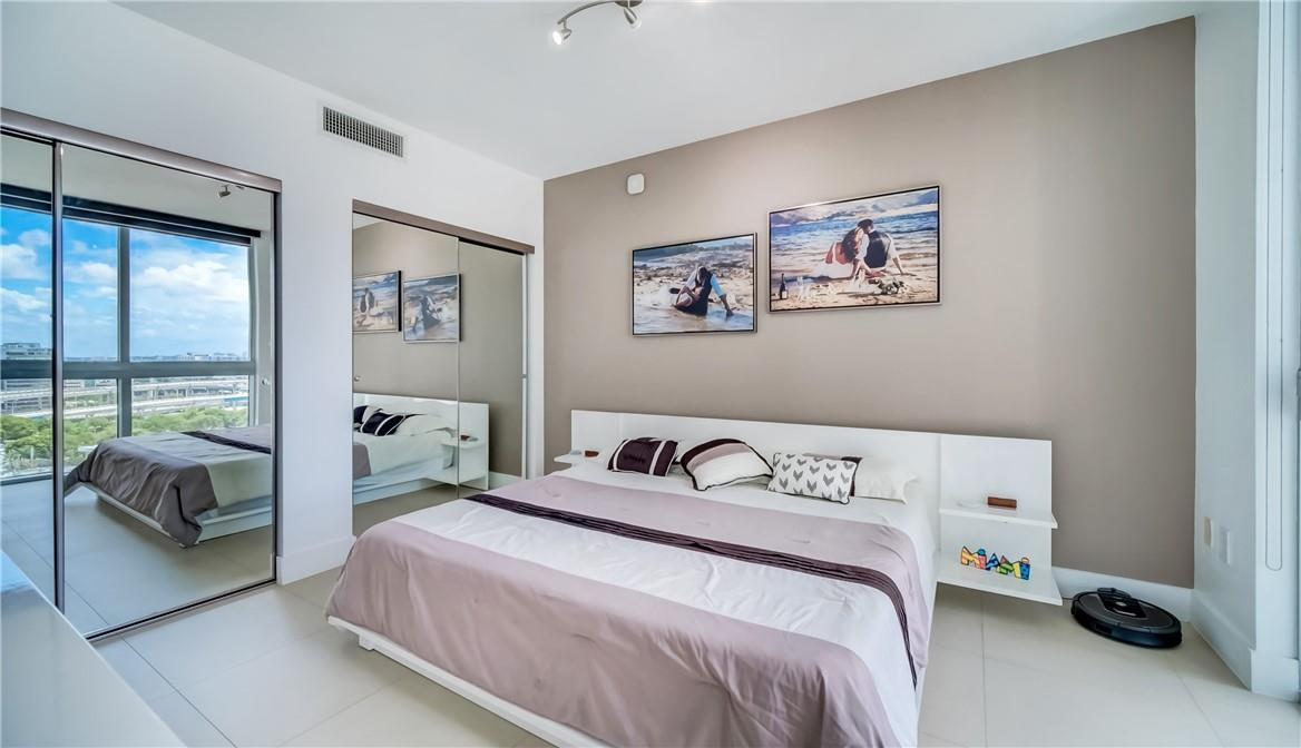 92 Southwest 3rd Street, Unit 1606 Miami, FL 33130 - Photo 13 of 62 a bedroom with a bed and a window