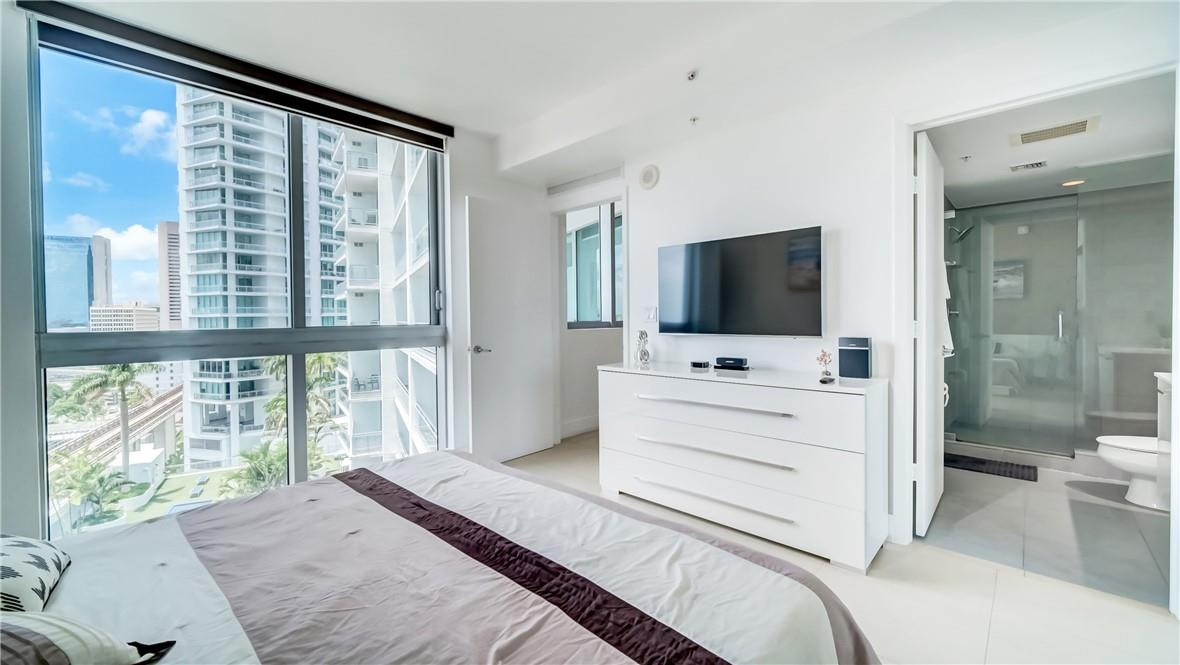 92 Southwest 3rd Street, Unit 1606 Miami, FL 33130 - Photo 14 of 62 a bedroom with a bed and a flat screen tv
