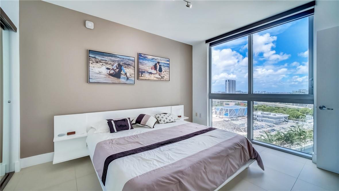 92 Southwest 3rd Street, Unit 1606 Miami, FL 33130 - Photo 15 of 62 a bedroom with a bed and a large window