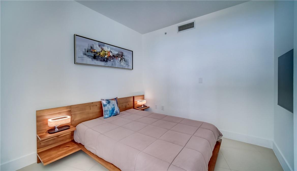 92 Southwest 3rd Street, Unit 1606 Miami, FL 33130 - Photo 17 of 62 a bedroom with a bed and painting on the wall