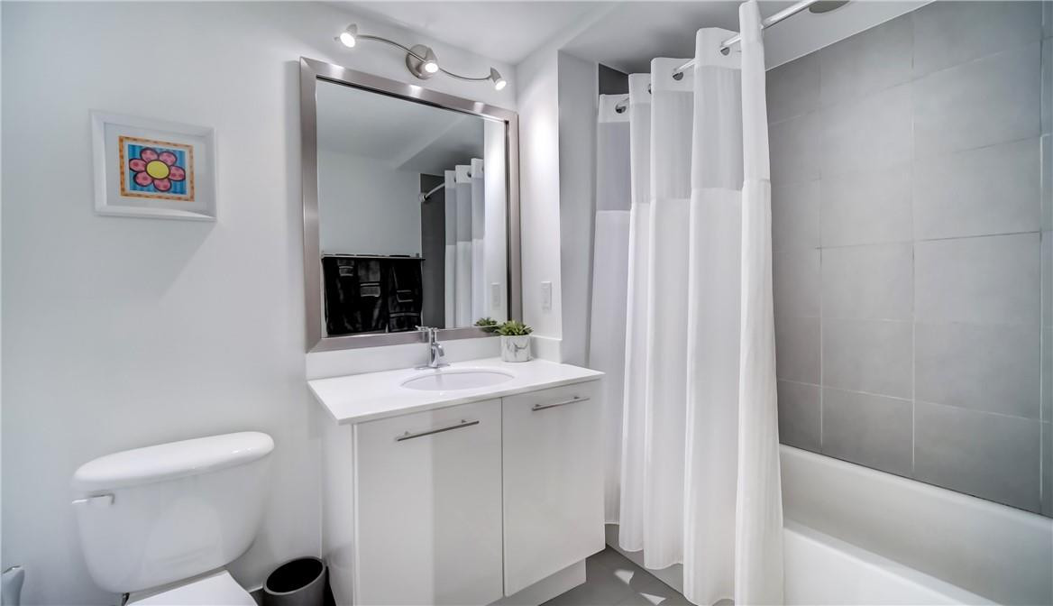 92 Southwest 3rd Street, Unit 1606 Miami, FL 33130 - Photo 18 of 62 a bathroom with a sink a toilet and shower