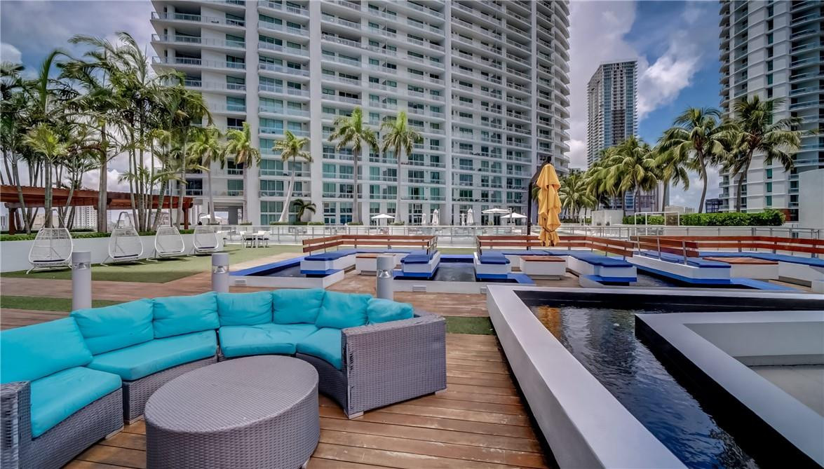 92 Southwest 3rd Street, Unit 1606 Miami, FL 33130 - Photo 29 of 62 a view of a swimming pool and lounge chairs