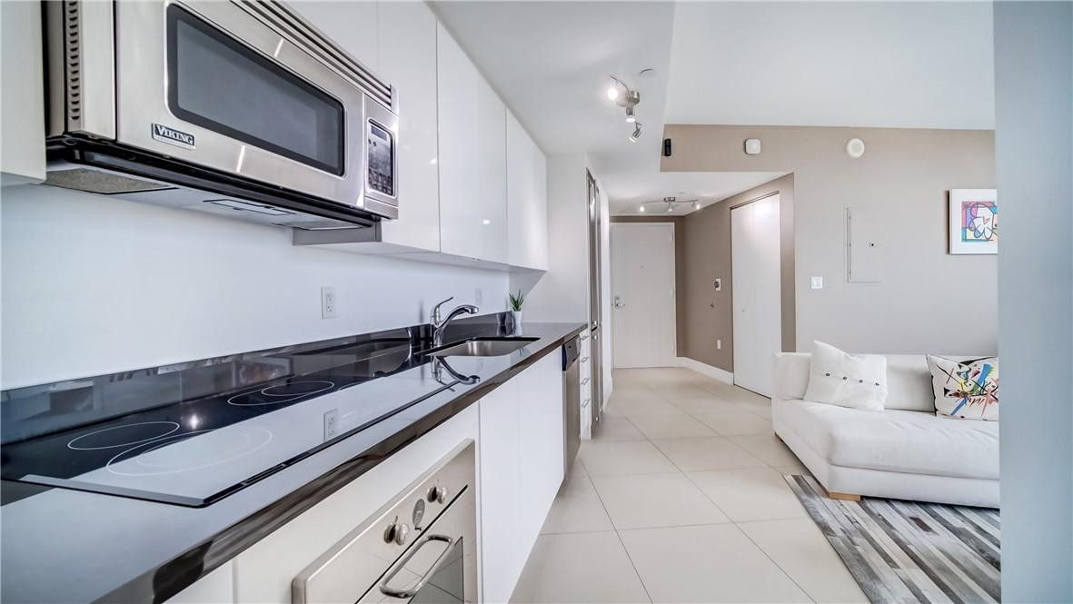92 Southwest 3rd Street, Unit 1606 Miami, FL 33130 - Photo 3 of 62 a kitchen with stainless steel appliances granite countertop a sink and a stove