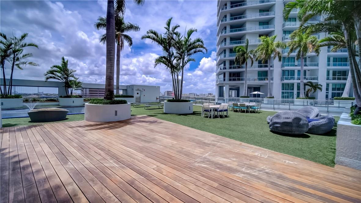 92 Southwest 3rd Street, Unit 1606 Miami, FL 33130 - Photo 34 of 62 a palm tree sitting in front of a house with a yard