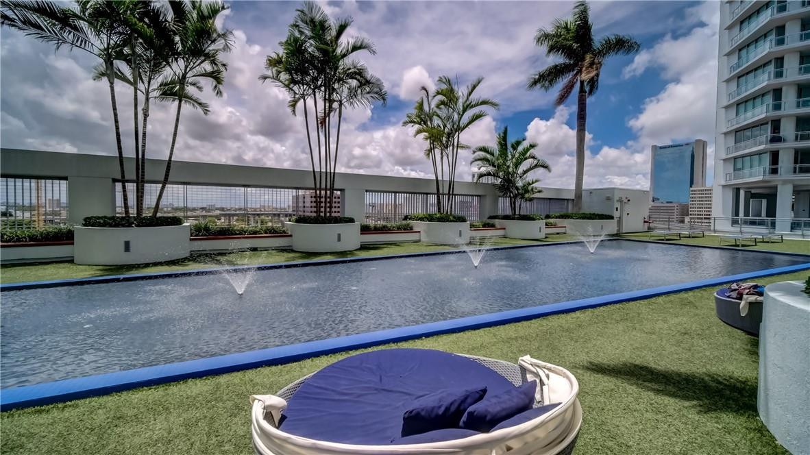 92 Southwest 3rd Street, Unit 1606 Miami, FL 33130 - Photo 44 of 62 a swimming pool with outdoor seating and yard