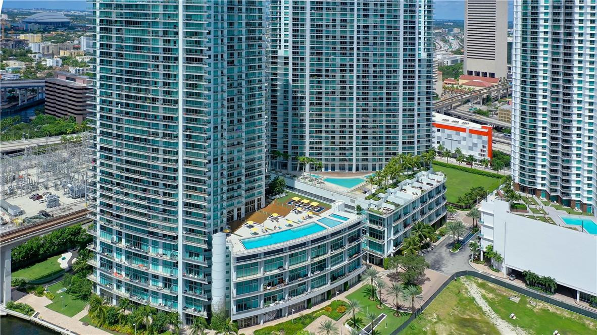 92 Southwest 3rd Street, Unit 1606 Miami, FL 33130 - Photo 58 of 62 a view of a balcony with chairs and a potted plant